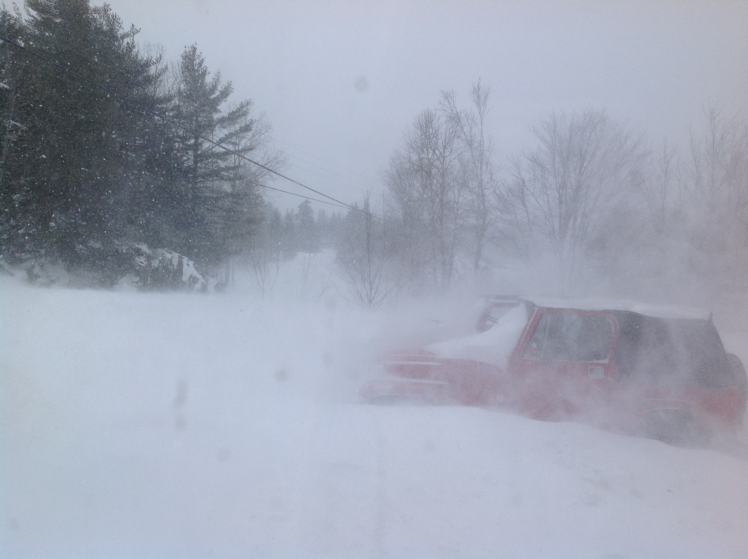 Vehicle nearly buried in blizzard conditions